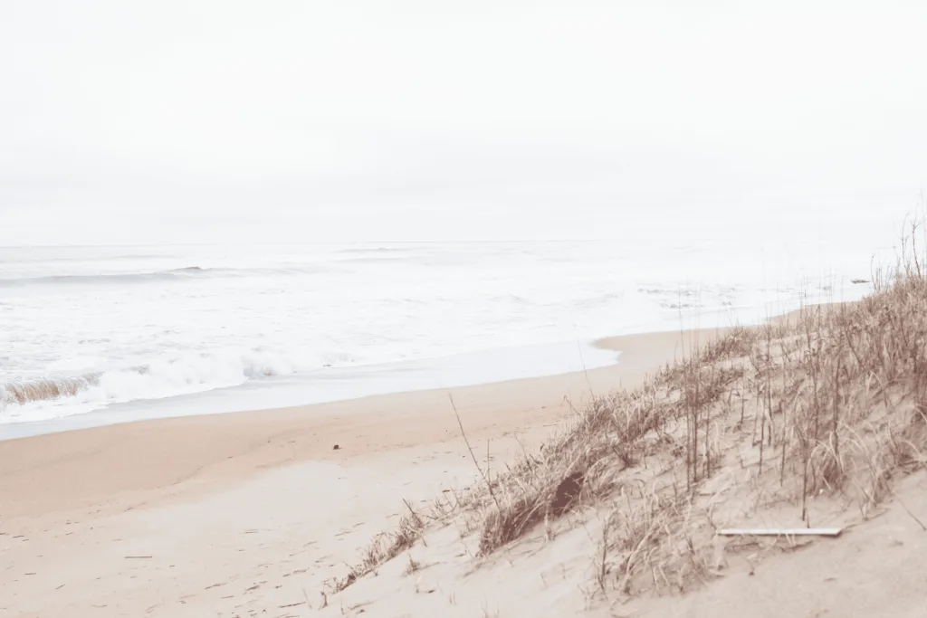 Soft morning surf rolling onto a dune-lined North Carolina beach