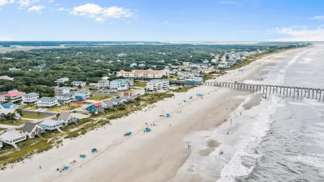 Aerial view of the beachfront, fishing pier and homes at Oak Island, North Carolina
